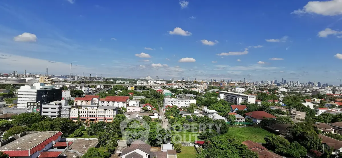 Stunning cityscape view with lush greenery and skyline in the distance.