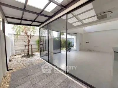 Modern open-plan living area with large glass doors and garden view