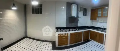 Spacious kitchen with modern appliances and stylish tile flooring in a contemporary home.