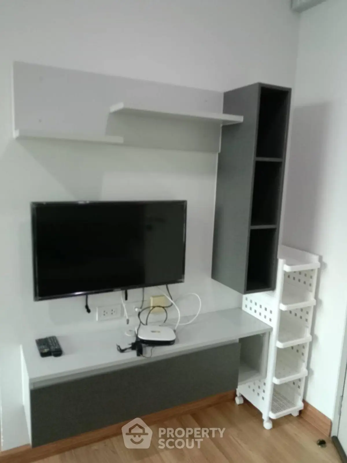 Modern living room with sleek TV unit and storage shelves, perfect for contemporary urban living.