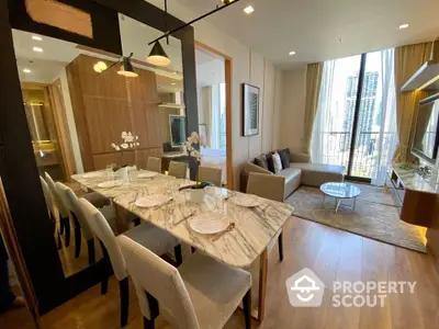 Elegant dining area seamlessly connects to a cozy living room, featuring a marble table, modern lighting, and floor-to-ceiling windows with city views.