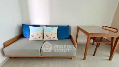 Cozy living room with modern sofa and wooden table, perfect for relaxation and work-from-home setup.