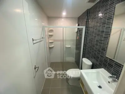 Modern bathroom with glass shower and sleek tile design