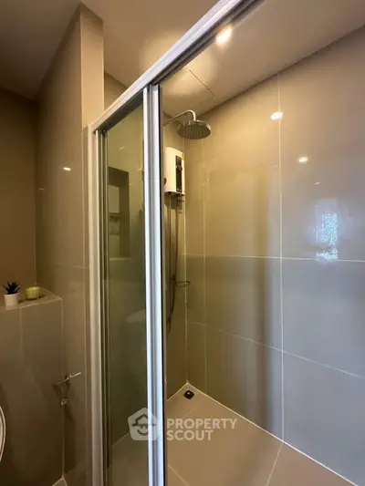 Modern bathroom with sleek shower enclosure and contemporary fixtures.