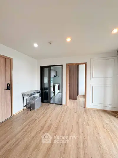 Spacious modern apartment with wooden flooring and sleek kitchen design