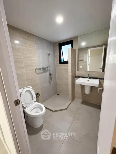 Modern bathroom with sleek design and walk-in shower in a contemporary apartment.