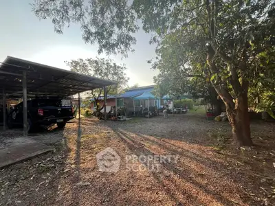 Charming rural property with carport and lush greenery, perfect for tranquil living.