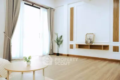 Spacious minimalist living room with natural light and elegant decor