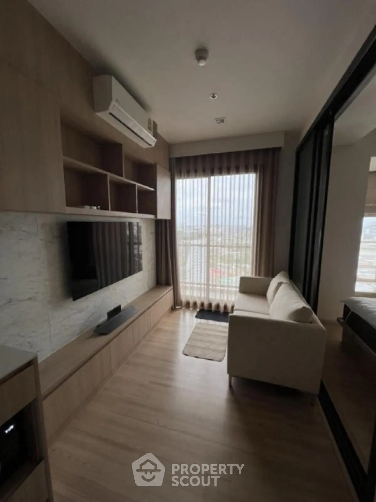 Modern living room with sleek design, large window, and cozy sofa in a stylish apartment.