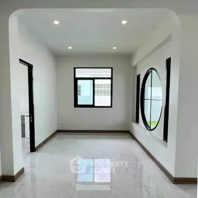 Modern minimalist room with large windows and glossy white flooring