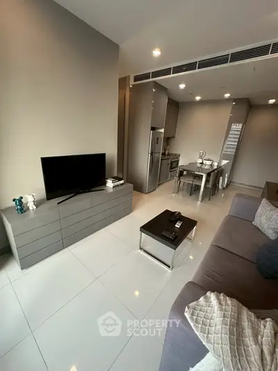 Modern open-plan living room with sleek kitchen and stylish decor