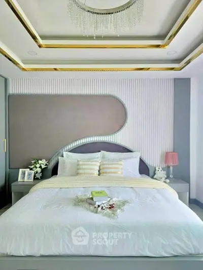 Luxurious modern bedroom with elegant ceiling design and plush bedding.