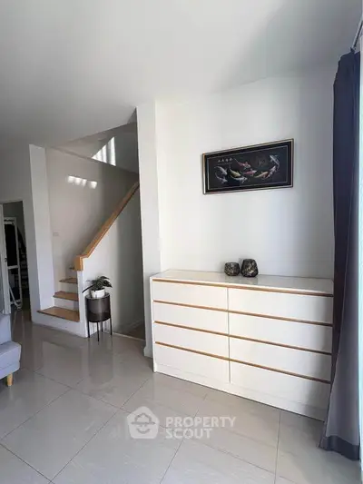 Modern interior with sleek staircase and stylish decor in a bright living space.