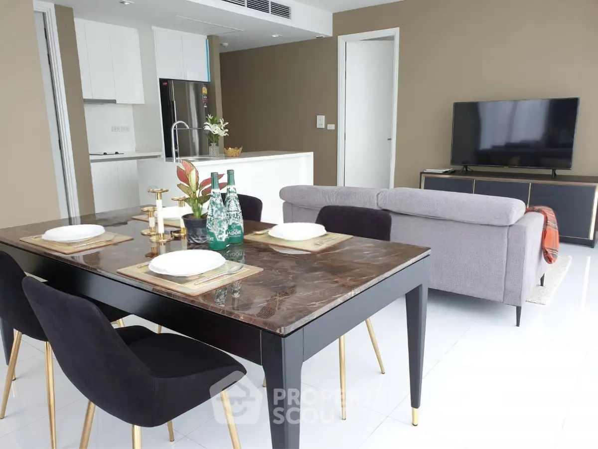 Modern open-plan living room with elegant dining area and sleek kitchen