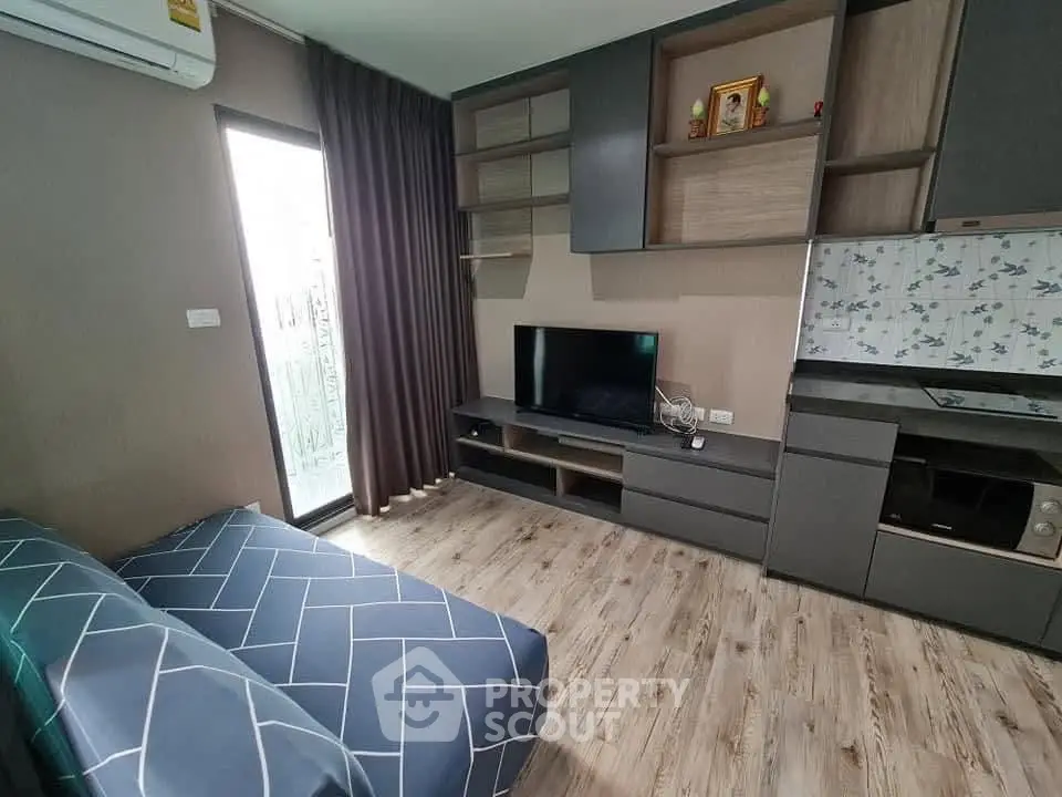 Modern living room with stylish shelving and entertainment center, featuring a cozy sofa and elegant flooring.