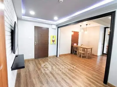 Spacious modern living room with open dining area and wooden flooring