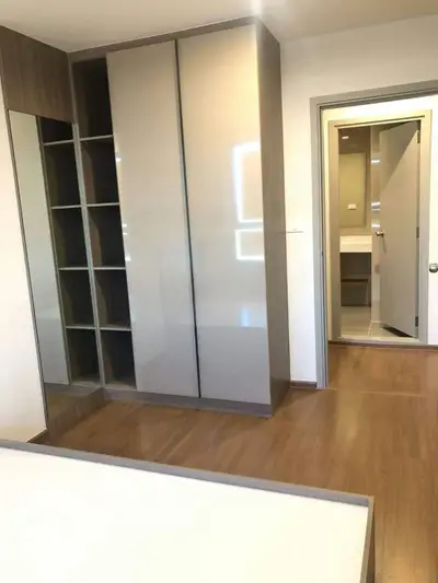 Modern bedroom with sleek built-in wardrobe and wooden flooring