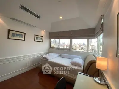 Bright and cozy bedroom with city view, featuring elegant decor and ample natural light.