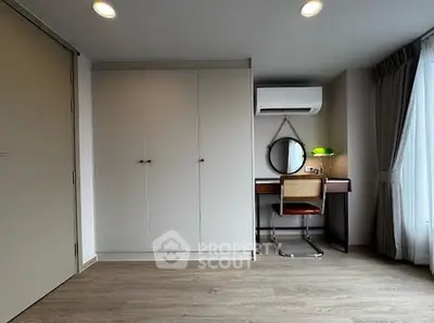 Modern bedroom with sleek wardrobe and stylish desk setup