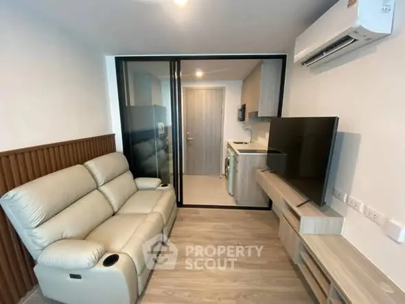 Modern living room with sleek furniture and open kitchen layout