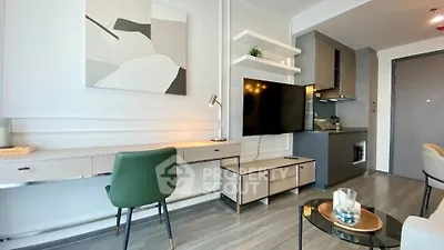 Modern living room with sleek furniture and integrated kitchen area, perfect for urban living.