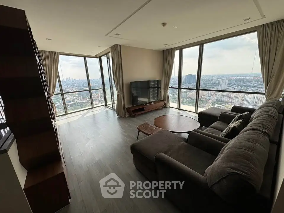 Spacious living room with panoramic city views and modern furnishings