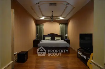 Luxurious bedroom with elegant wooden flooring and stylish ceiling design