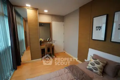 Modern bedroom with stylish decor and large mirror in a cozy apartment