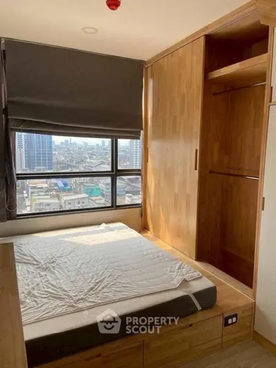 Cozy bedroom with wooden wardrobe and city view window