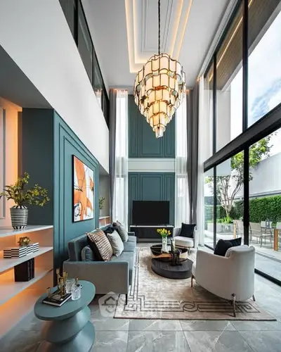 Luxurious double-height living room with modern decor and large windows