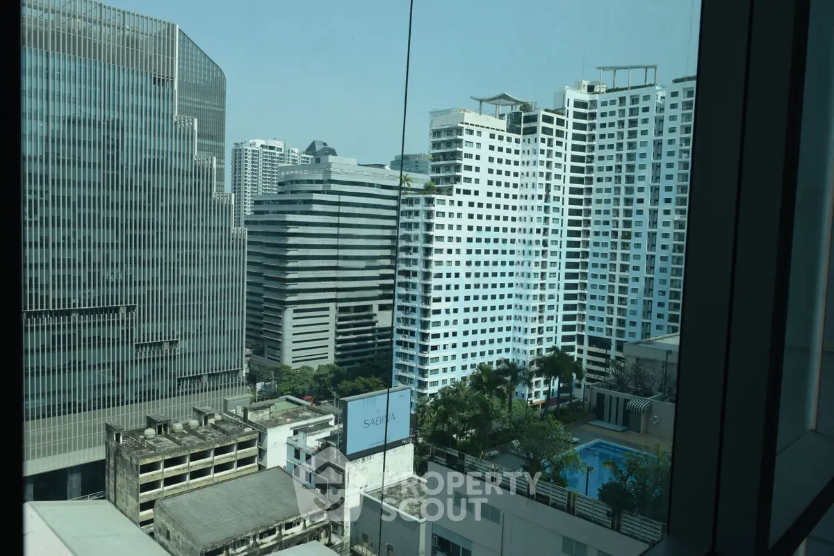 Stunning cityscape view from high-rise building window showcasing modern architecture and urban skyline.
