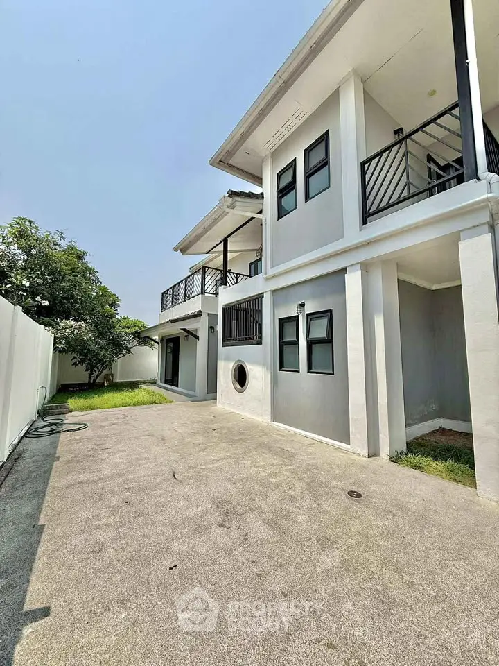 Spacious modern two-story house with a private garden and balcony, perfect for family living.