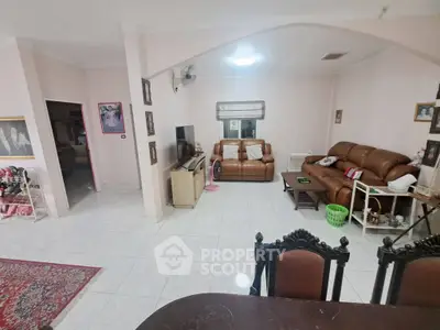 Spacious living room with cozy seating and elegant decor, perfect for family gatherings.