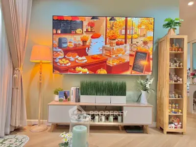 Charming living room with modern decor and large TV, perfect for cozy evenings.
