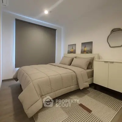Modern bedroom with stylish decor and cozy ambiance, featuring a comfortable bed and elegant furnishings.