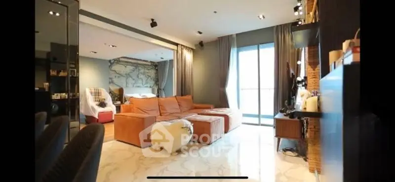 Spacious modern living room with cozy sectional sofa and large windows for natural light.