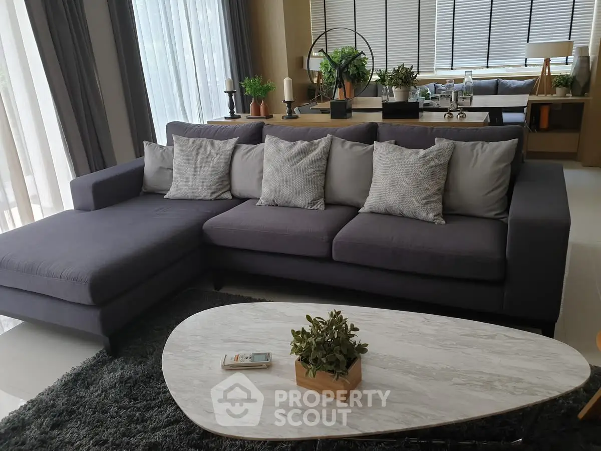 Modern living room with stylish gray sofa and elegant decor