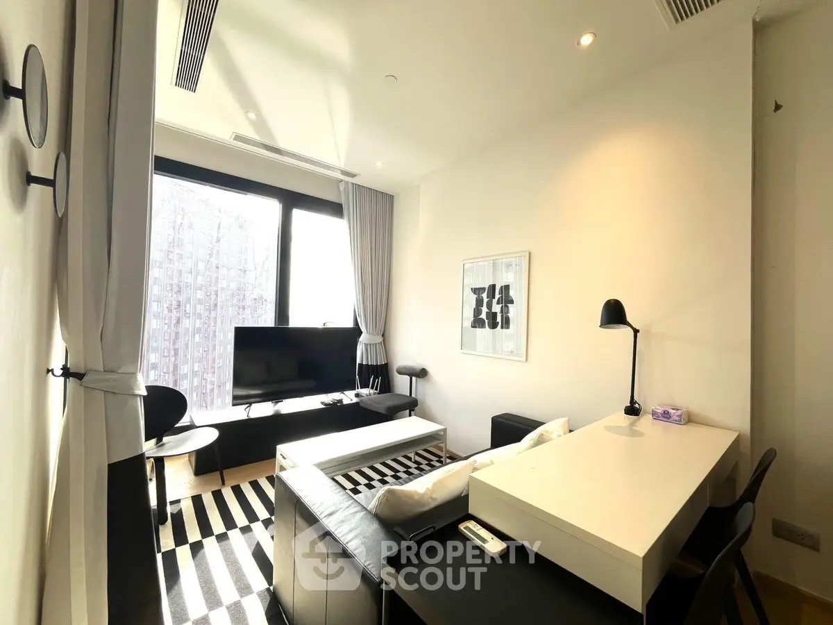 Modern living room with stylish decor and large window offering city views.