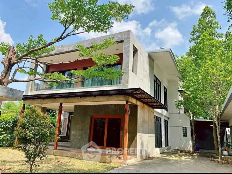 Modern two-story house with large windows and lush greenery, perfect for contemporary living.