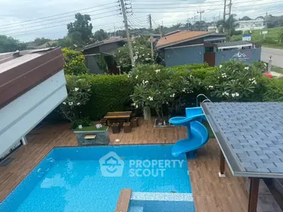 Stunning backyard with pool and slide, perfect for family fun and relaxation.