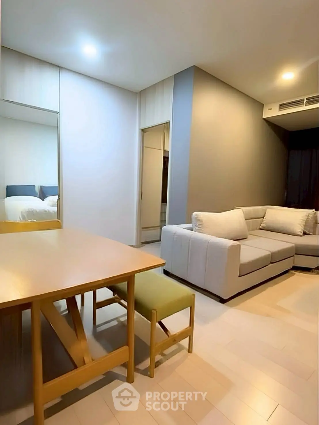 Modern living room with cozy sofa and dining area in open layout apartment