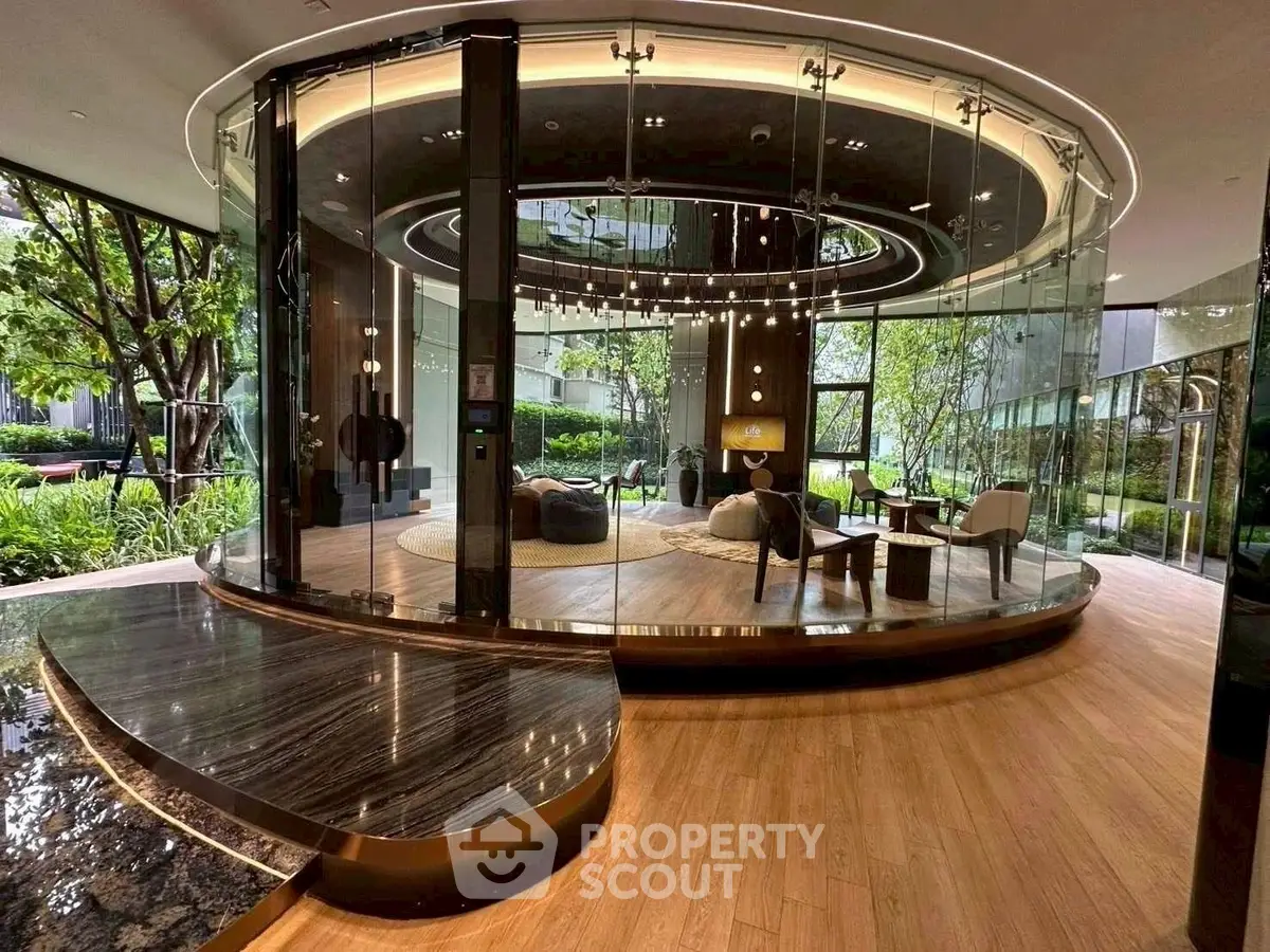 Luxurious modern living room with glass walls and elegant decor in a high-end property.
