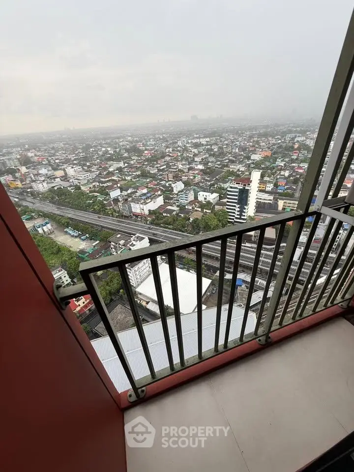 Stunning high-rise balcony view overlooking cityscape with expansive skyline.