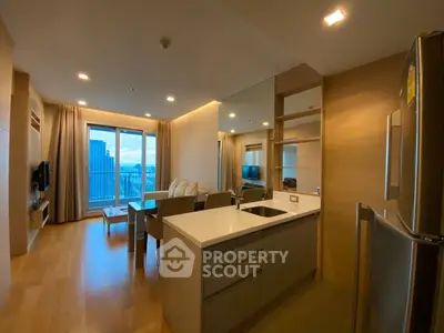 Modern open-layout living room with kitchen, featuring city view and sleek design.