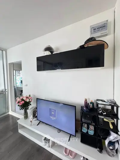 Modern living room with sleek TV setup and stylish storage solutions.