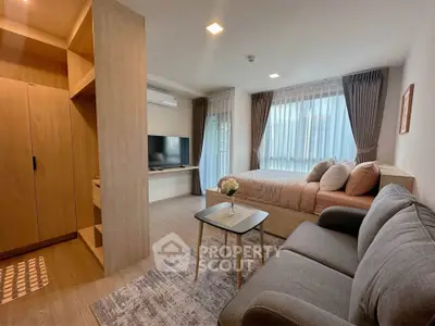 Modern studio apartment with cozy living area and stylish decor