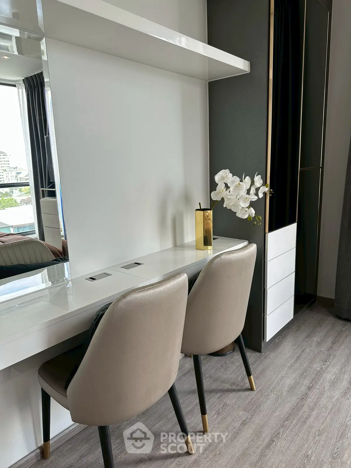 Modern study area with sleek design and elegant chairs in a stylish apartment.