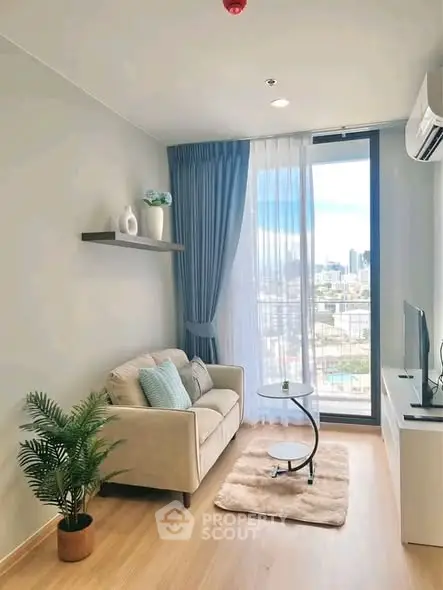 Chic modern living room with city view, cozy sofa, and elegant decor in a high-rise apartment.