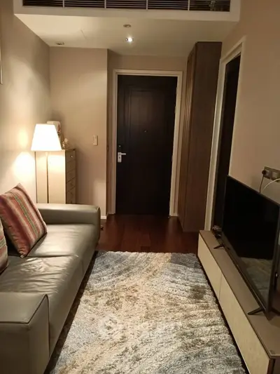 Cozy living room with modern decor and comfortable seating in a stylish apartment.