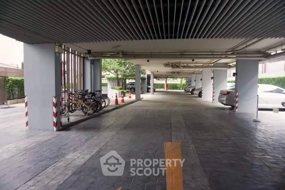 Spacious covered parking area with ample space and bicycle racks in modern building